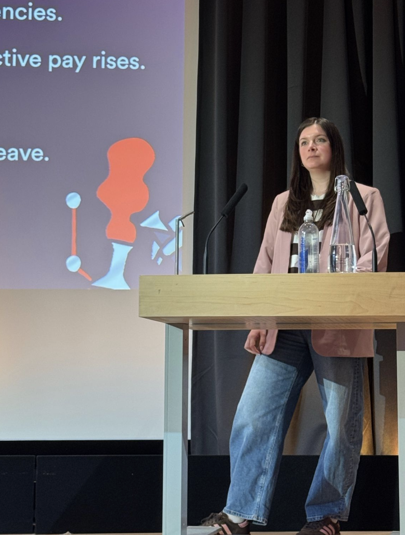 Zoë Blogg speaking at a podium