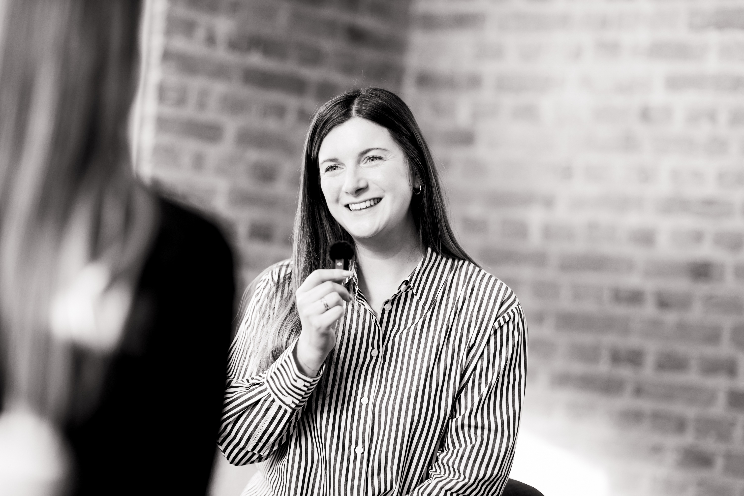 Zoë Blogg speaking with a small handheld microphone